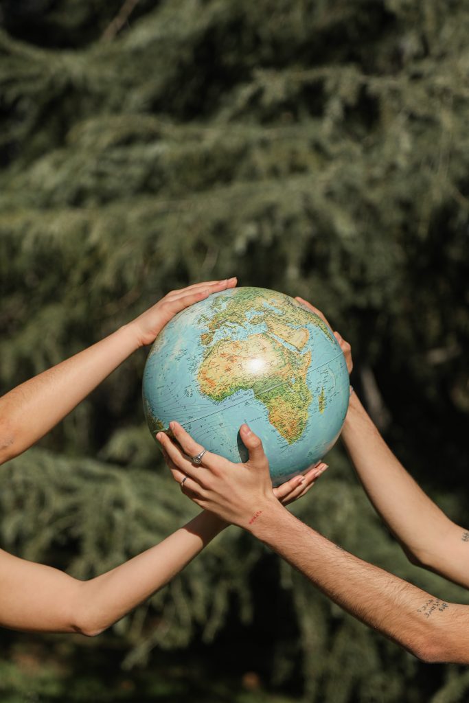 Hands holding a globe for eco friendly responsibilities